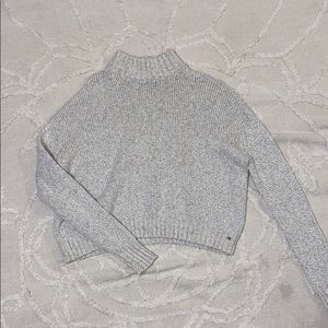 Cream-gray turtleneck sweater.